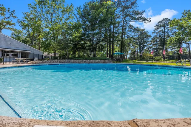 a view of pool and trees in the background