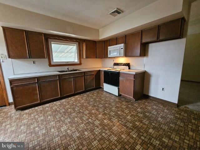 1836 3rd Street Langhorne, PA 19047 - Photo 5 of 14 a kitchen with stainless steel appliances granite countertop a stove a sink and a refrigerator