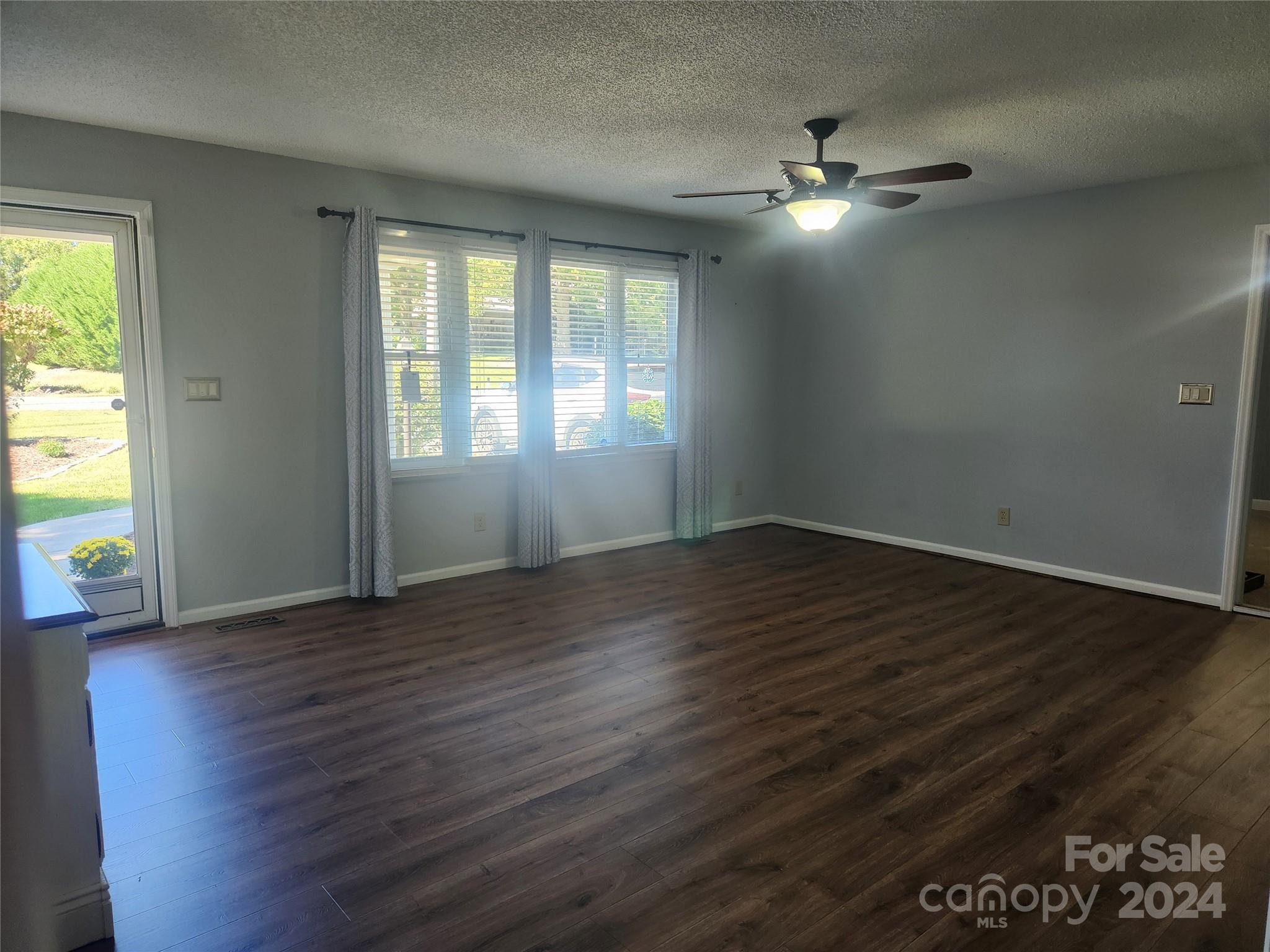 338 Helmstetler Road Lexington, NC 27295 - Photo 5 of 38 an empty room with wooden floor and windows