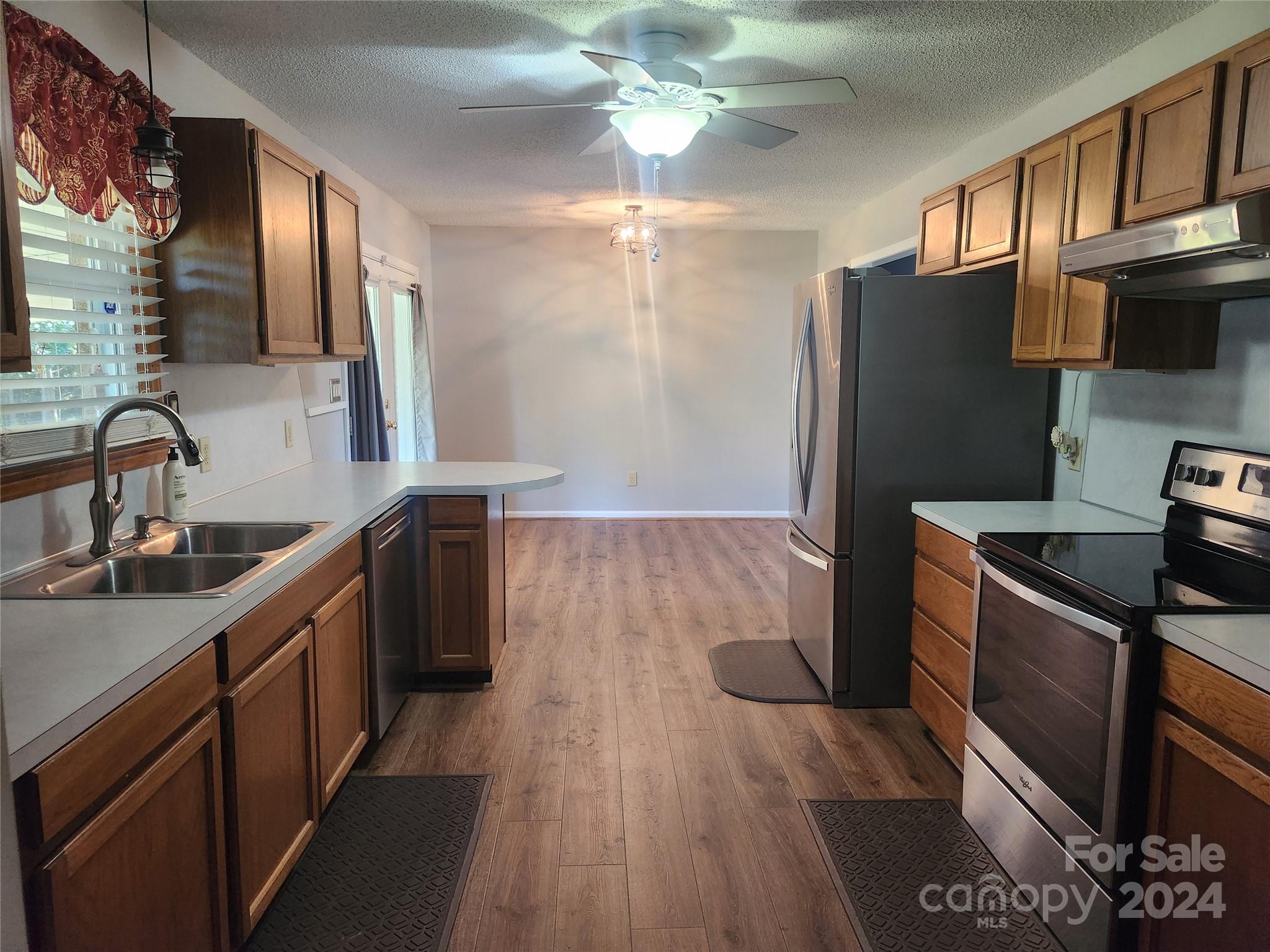 338 Helmstetler Road Lexington, NC 27295 - Photo 6 of 38 a kitchen with stainless steel appliances granite countertop a sink stove and refrigerator