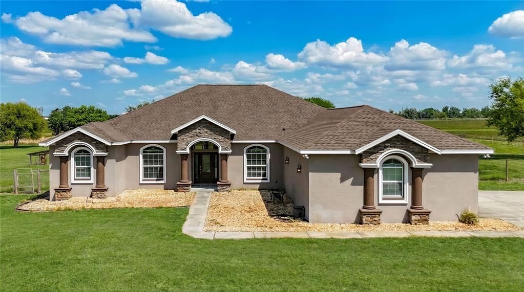 a front view of a house with a yard