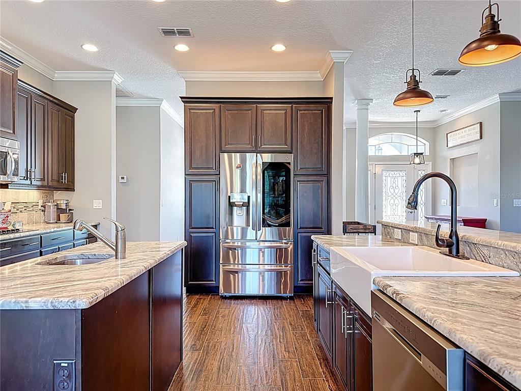 2350 Virgil Hall Road Lithia, FL 33547 - Photo 11 of 52 a kitchen with stainless steel appliances granite countertop a sink and a refrigerator