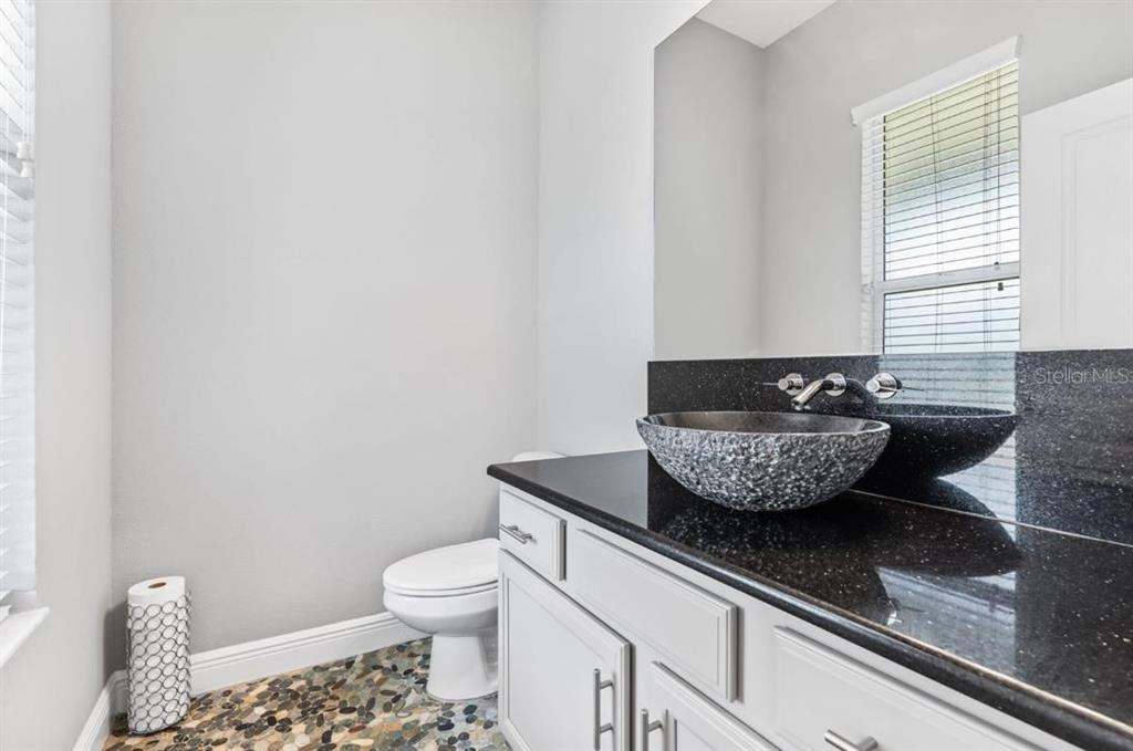 2350 Virgil Hall Road Lithia, FL 33547 - Photo 22 of 52 a living room with a couch and a potted plant
