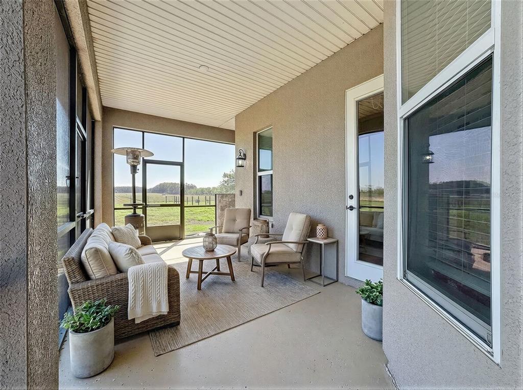 2350 Virgil Hall Road Lithia, FL 33547 - Photo 25 of 52 a living room with furniture and floor to ceiling windows