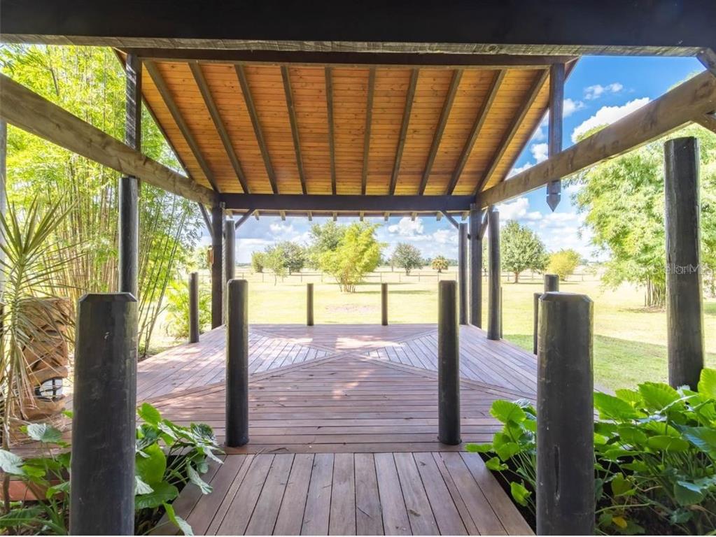 2350 Virgil Hall Road Lithia, FL 33547 - Photo 30 of 52 a view of porch with wooden floor and furniture