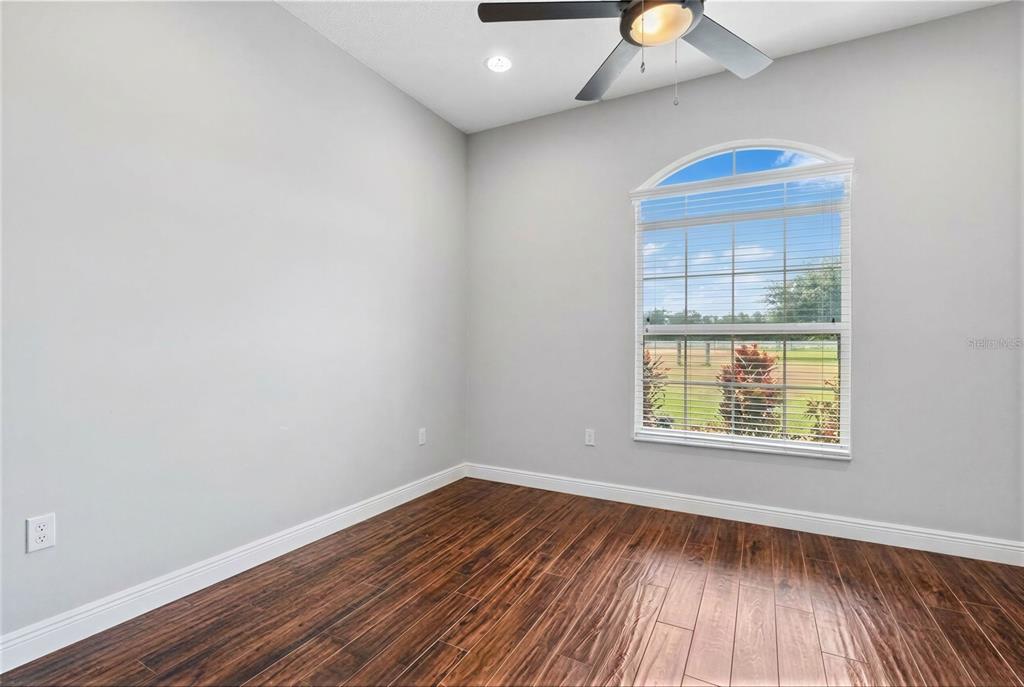 2350 Virgil Hall Road Lithia, FL 33547 - Photo 41 of 52 an empty room with wooden floor and windows