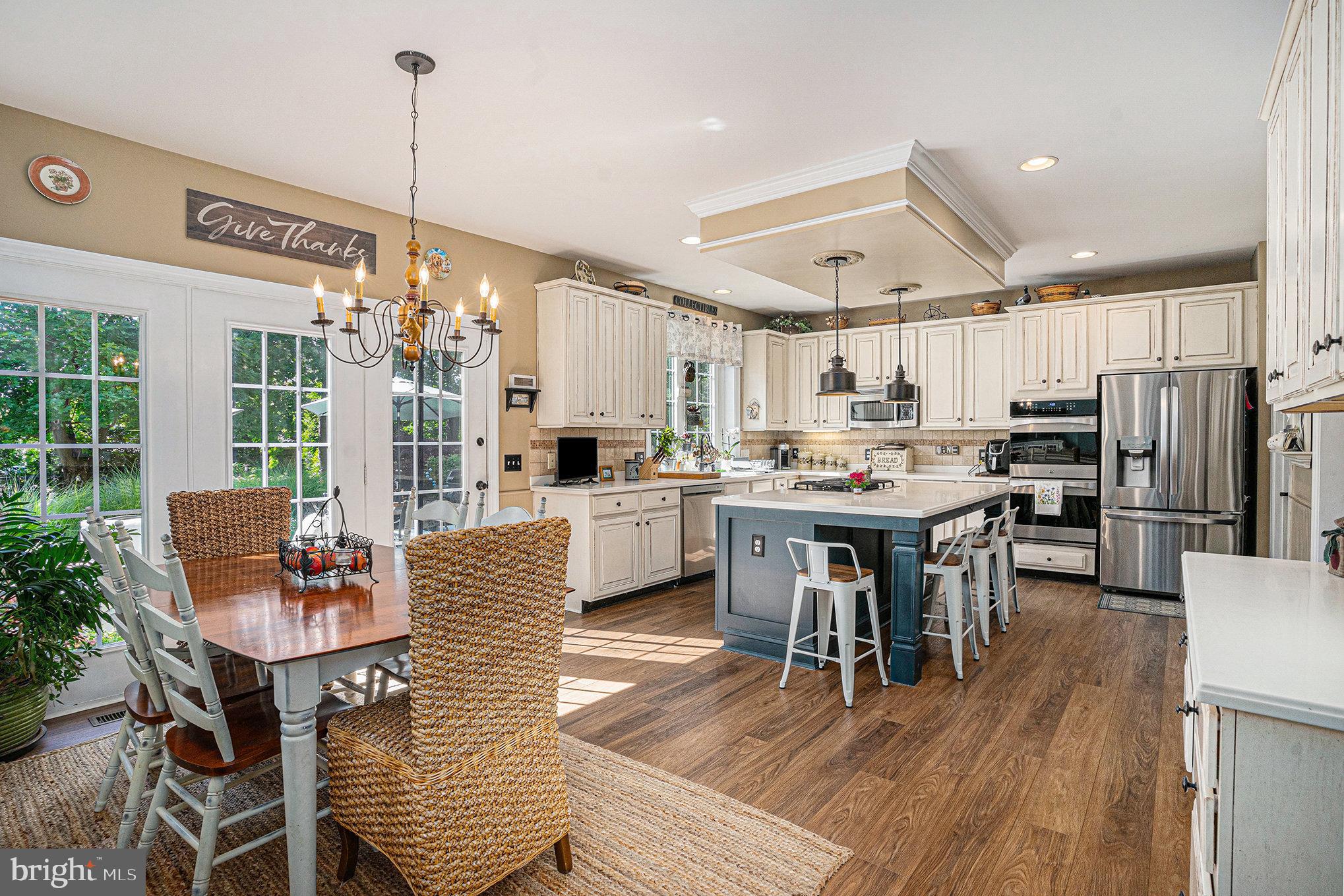 1250 Appalachian Road Ambler, PA 19002 - Photo 13 of 58 a open kitchen with stainless steel appliances kitchen island granite countertop a table chairs and a refrigerator