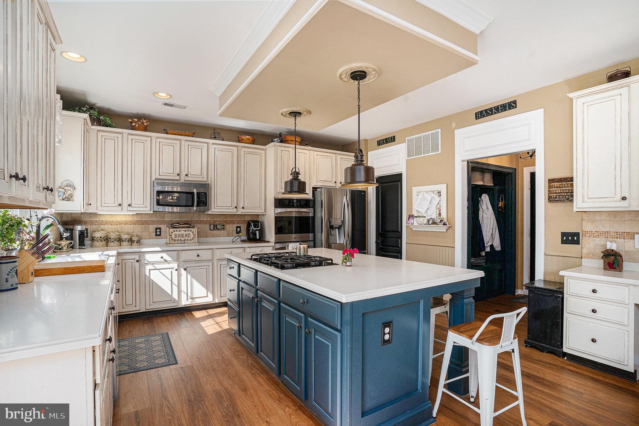 1250 Appalachian Road Ambler, PA 19002 - Photo 9 of 58 a kitchen with stainless steel appliances granite countertop a refrigerator a stove top oven a sink dishwasher and white cabinets with wooden floor