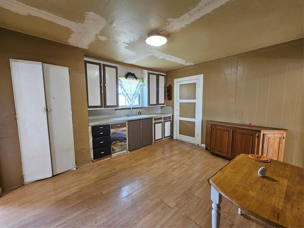 127 East Morgan Street Pilot Point, TX 76258 - Photo 17 of 25 Kitchen with light wood-style floors and light countertops