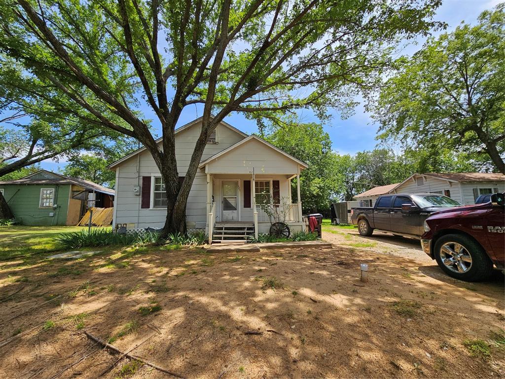 127 East Morgan Street Pilot Point, TX 76258 - Photo 2 of 25 View of front of property featuring a porch