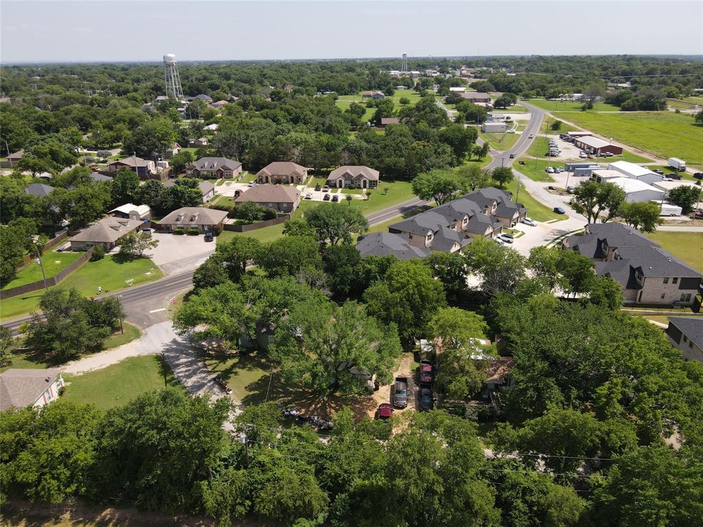 127 East Morgan Street Pilot Point, TX 76258 - Photo 23 of 25 Aerial view of residential area featuring a tree filled landscape