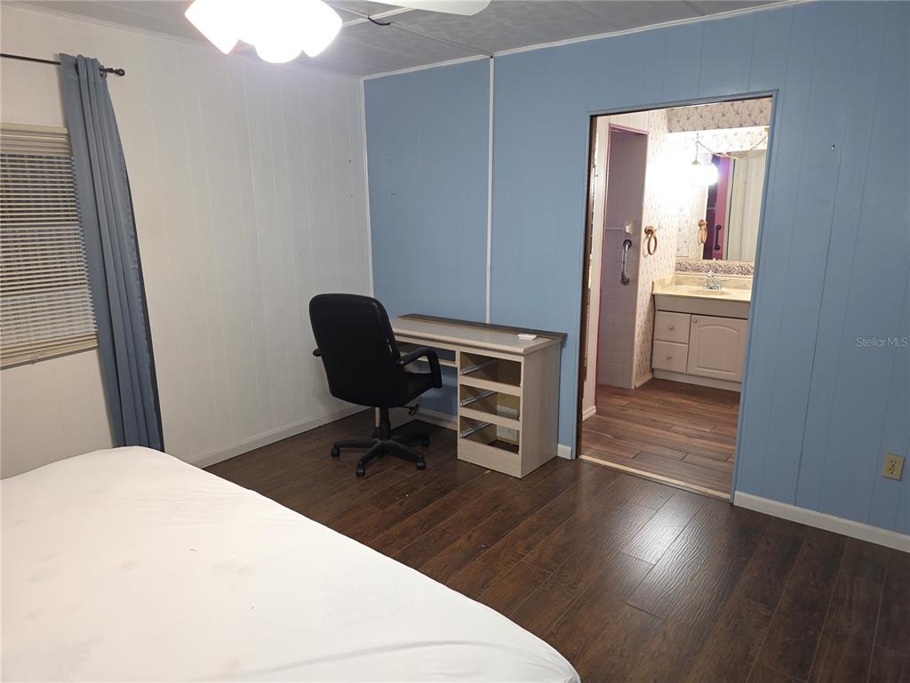 8071 Highpoint Boulevard Brooksville, FL 34613 - Photo 14 of 21 a workspace with wooden floor and furniture