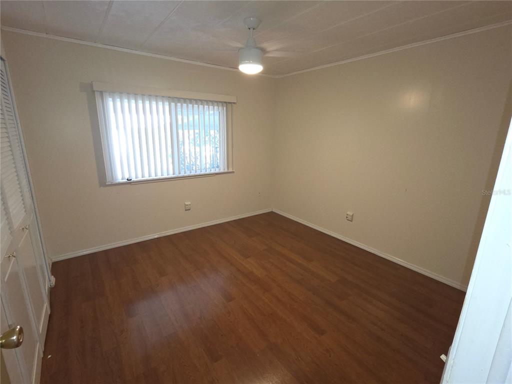 8071 Highpoint Boulevard Brooksville, FL 34613 - Photo 15 of 21 an empty room with wooden floor and windows