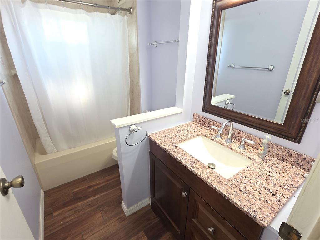 8071 Highpoint Boulevard Brooksville, FL 34613 - Photo 16 of 21 a bathroom with a granite countertop sink and a mirror