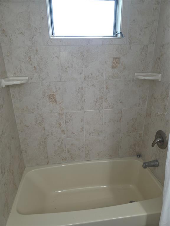 8071 Highpoint Boulevard Brooksville, FL 34613 - Photo 17 of 21 a close up of a bathtub in a bathroom