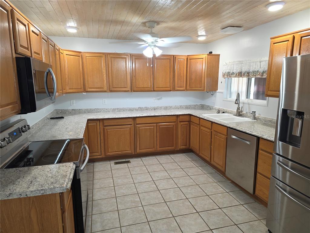8071 Highpoint Boulevard Brooksville, FL 34613 - Photo 4 of 21 a kitchen with stainless steel appliances granite countertop a sink and a stove
