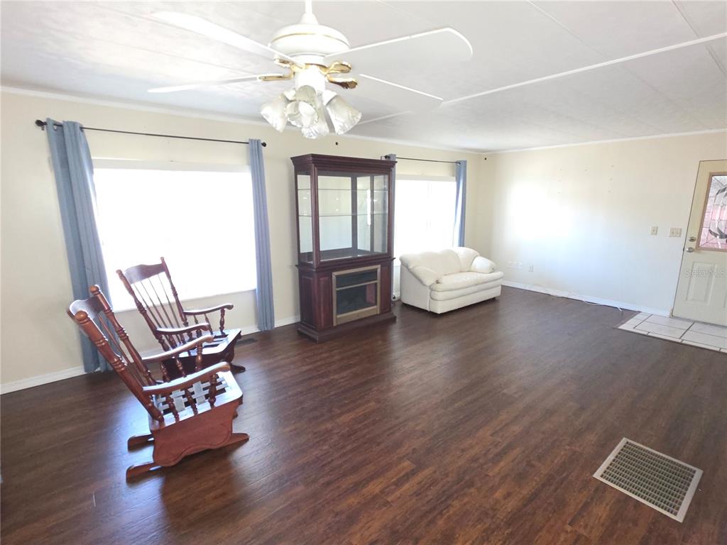8071 Highpoint Boulevard Brooksville, FL 34613 - Photo 7 of 21 a living room with furniture and wooden floor