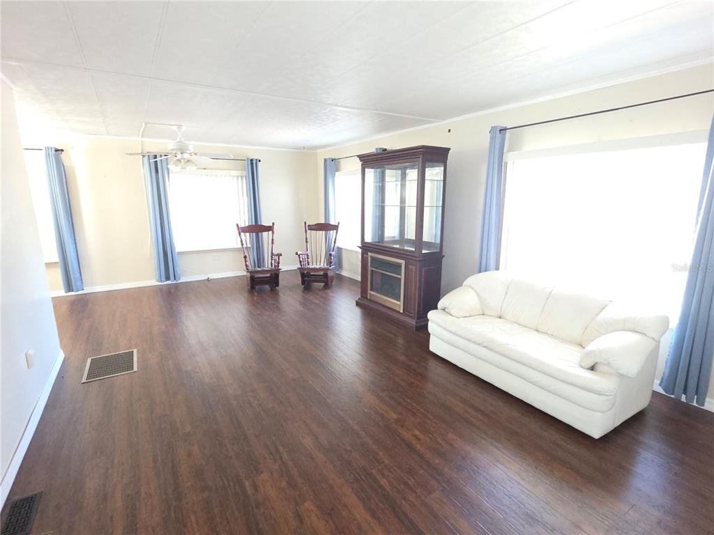 8071 Highpoint Boulevard Brooksville, FL 34613 - Photo 8 of 21 a living room with furniture and wooden floor