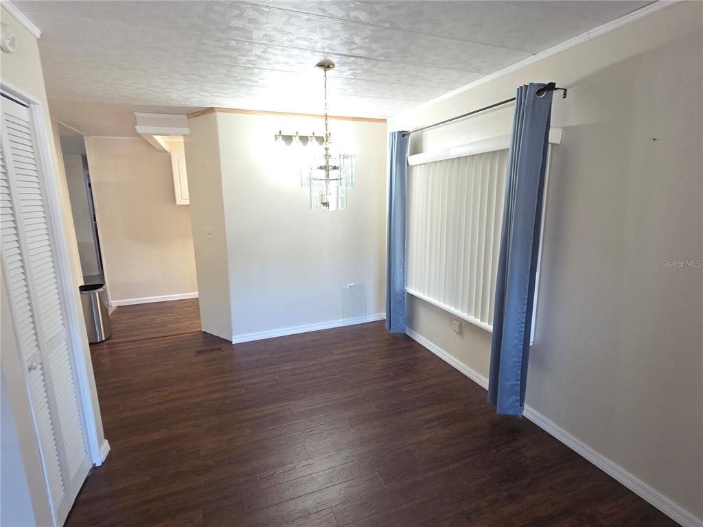 8071 Highpoint Boulevard Brooksville, FL 34613 - Photo 9 of 21 an empty room with wooden floor and staircase