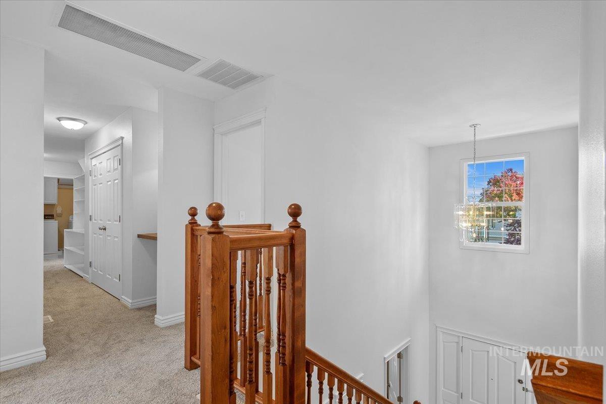1075 North Purple Sage Way Eagle, ID 83616 - Photo 22 of 44 Corridor featuring an upstairs landing and light colored carpet