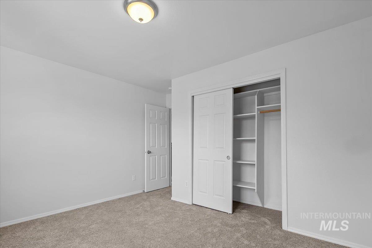 1075 North Purple Sage Way Eagle, ID 83616 - Photo 24 of 44 Unfurnished bedroom featuring light carpet and a closet