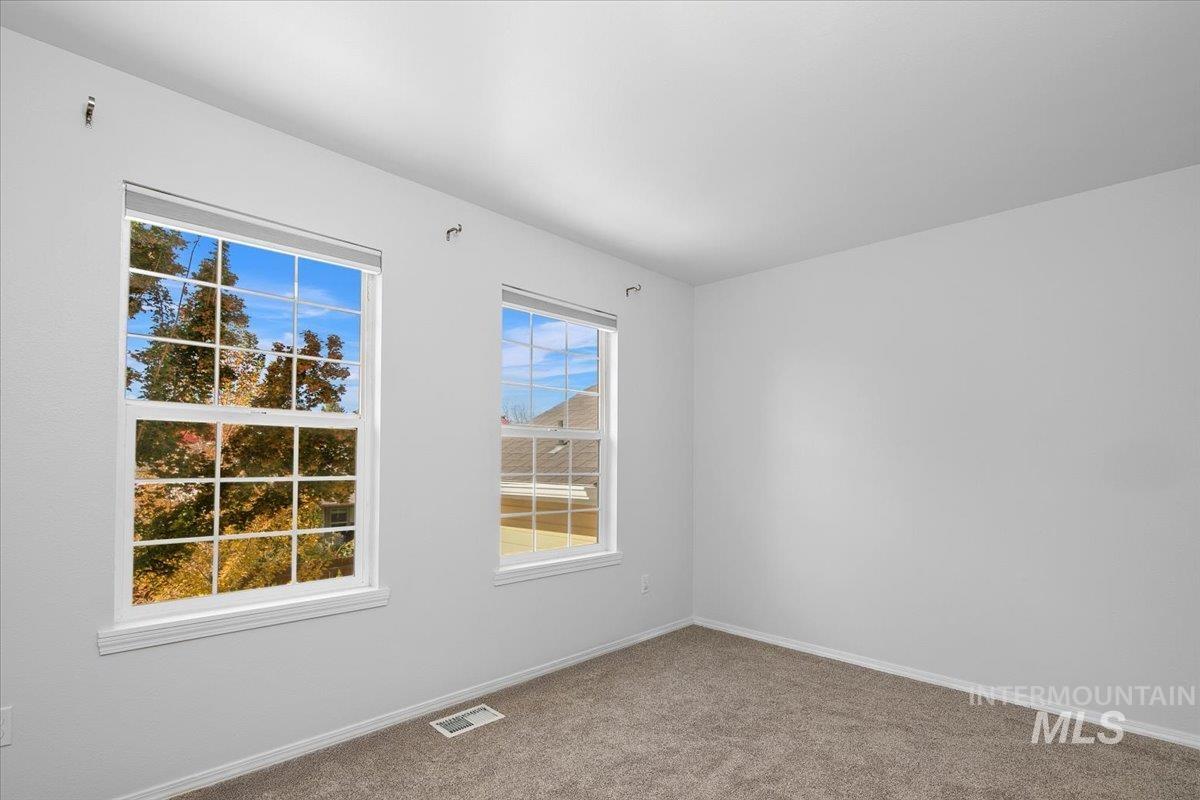 1075 North Purple Sage Way Eagle, ID 83616 - Photo 25 of 44 Carpeted spare room featuring baseboards