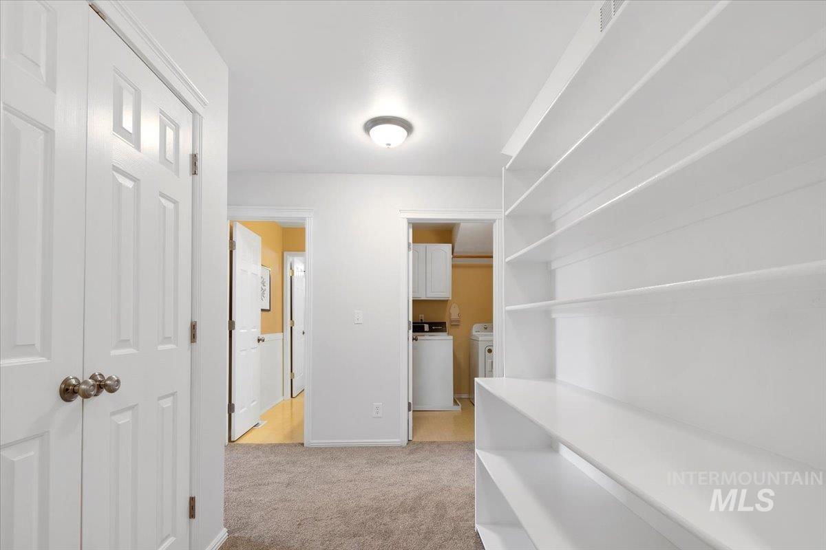 1075 North Purple Sage Way Eagle, ID 83616 - Photo 27 of 44 Corridor featuring light colored carpet and baseboards