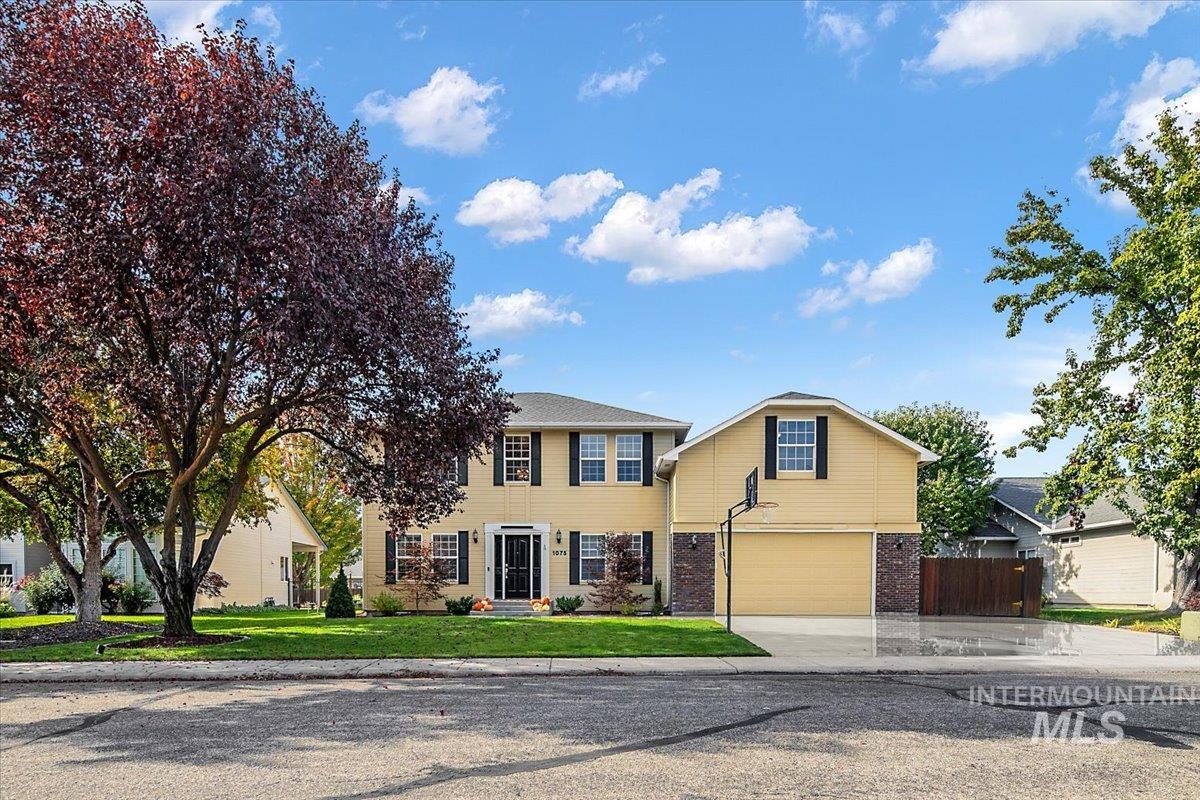 1075 North Purple Sage Way Eagle, ID 83616 - Photo 6 of 44 Colonial home featuring brick siding, driveway, and a garage