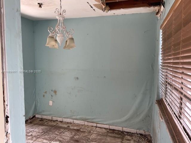 640 83rd Street Miami Beach, FL 33141 - Photo 12 of 13 a view of a room with a hanging light and hardwood floor