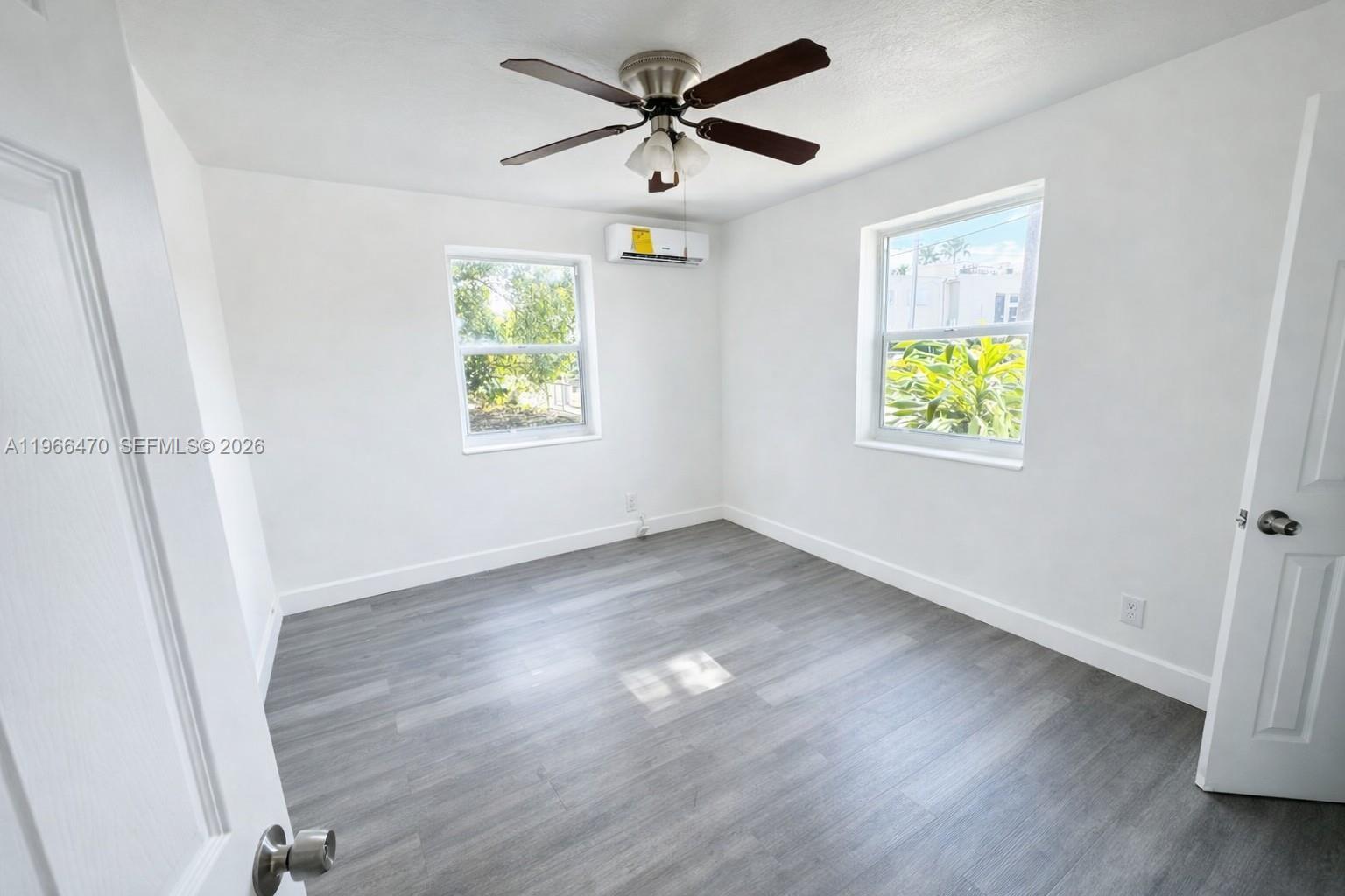 3450 Southwest 7th Street, Unit 3450 Miami, FL 33135 - Photo 3 of 7 wooden floor in an empty room with a window