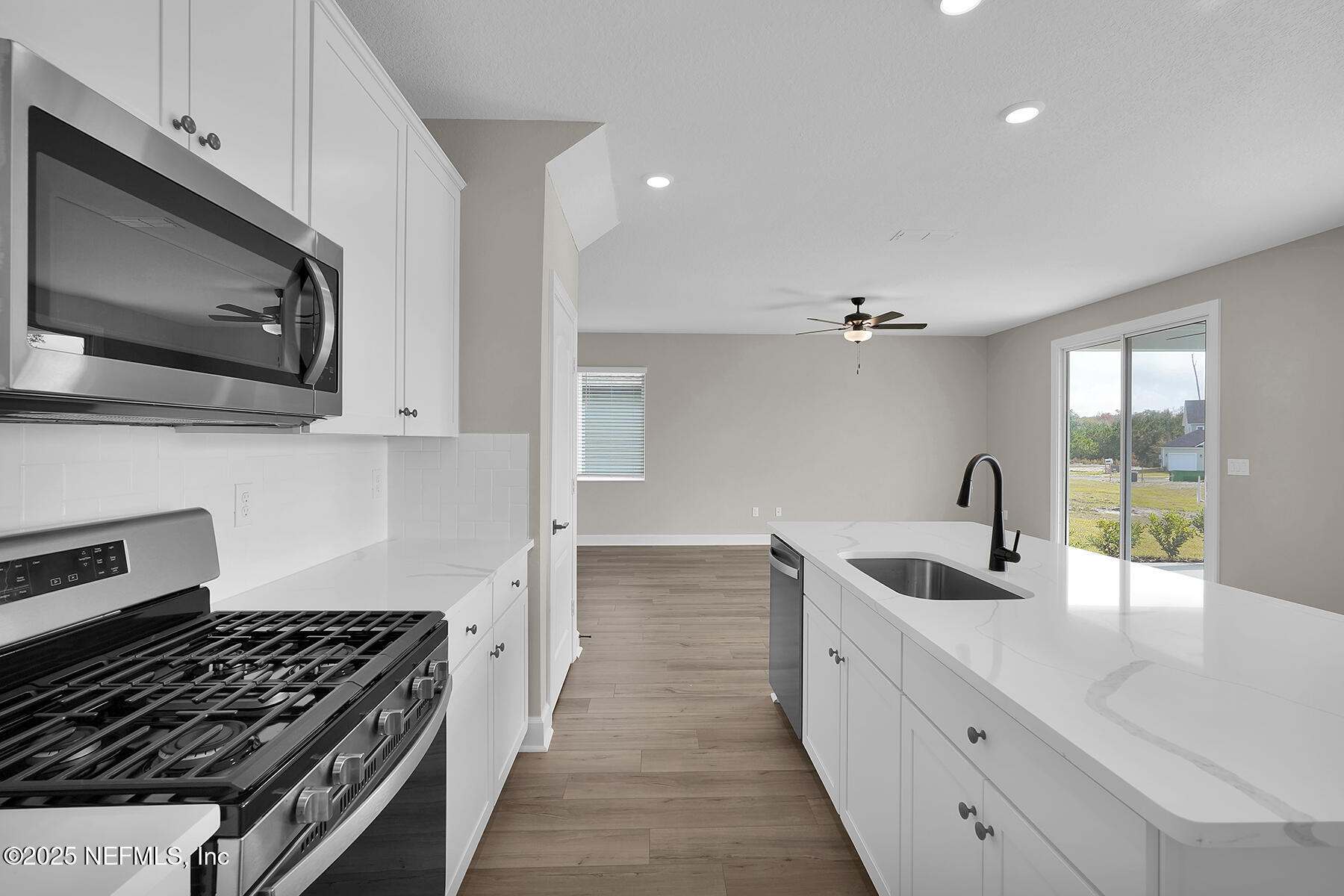 3987 Gareys Ferry Way Middleburg, FL 32068 - Photo 11 of 25 a kitchen with granite countertop a stove and a sink