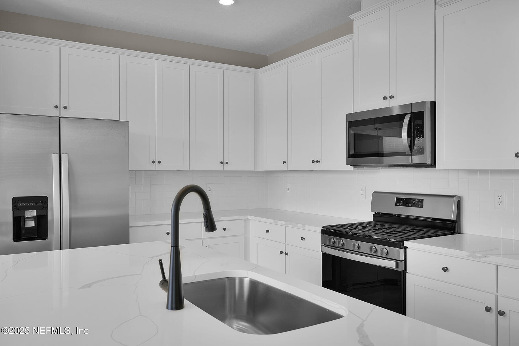 3987 Gareys Ferry Way Middleburg, FL 32068 - Photo 12 of 25 a kitchen with granite countertop white cabinets and stainless steel appliances