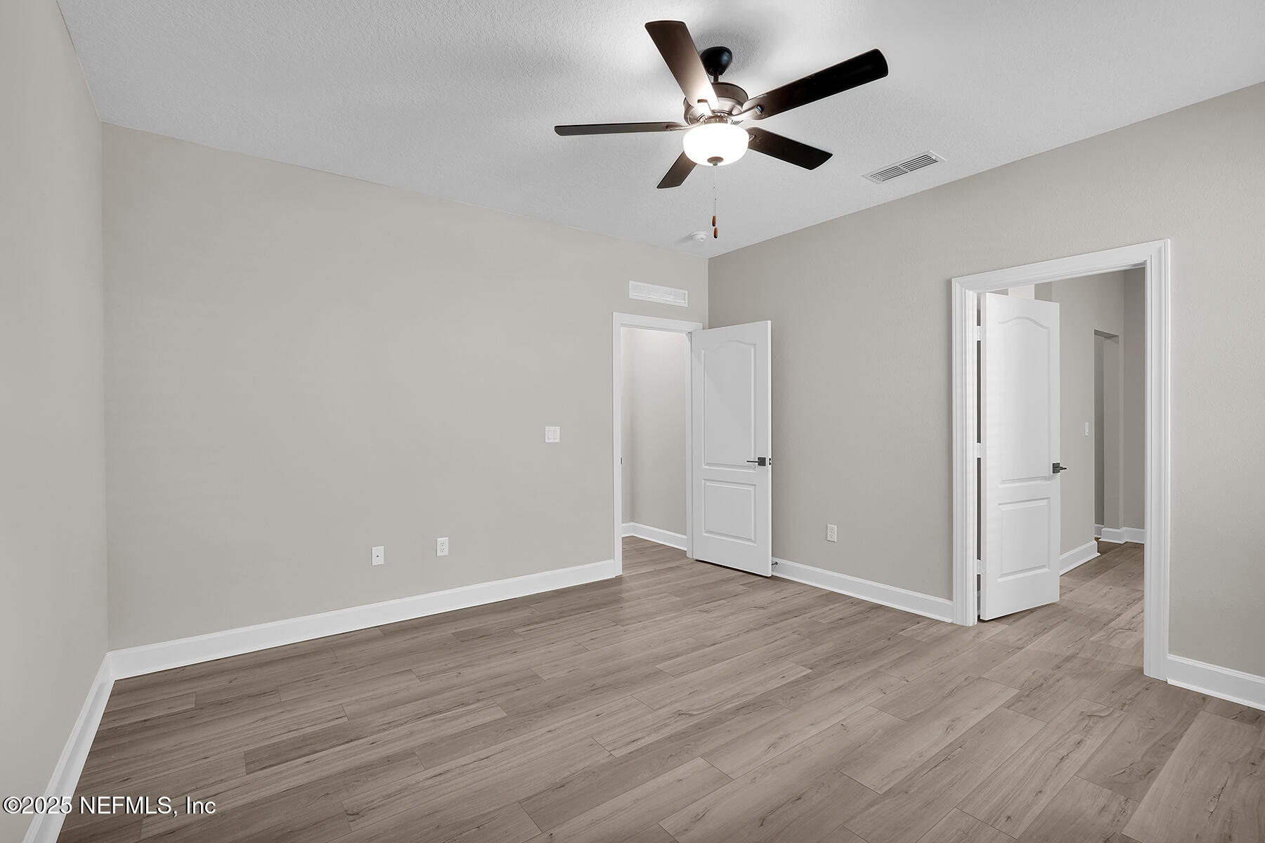 3987 Gareys Ferry Way Middleburg, FL 32068 - Photo 14 of 25 an empty room with wooden floor and ceiling fan