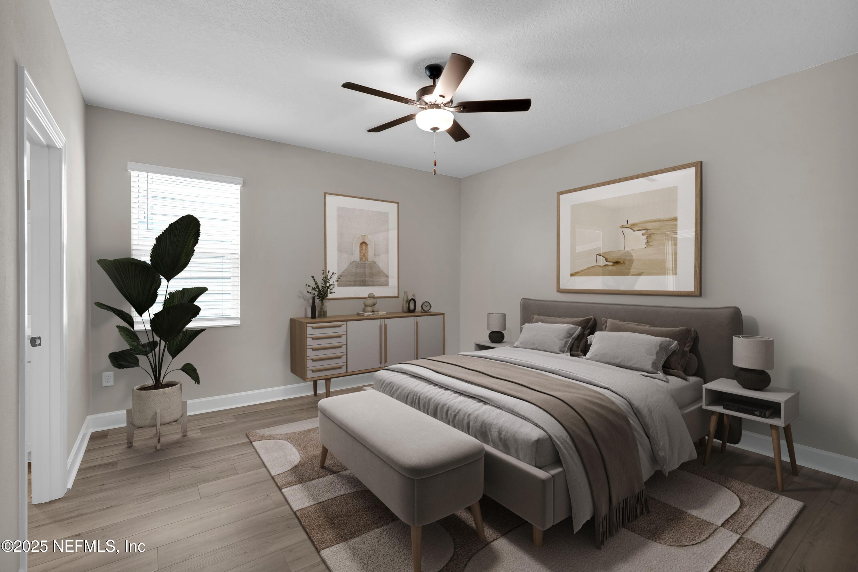 3987 Gareys Ferry Way Middleburg, FL 32068 - Photo 19 of 25 a bedroom with a bed and a chandelier