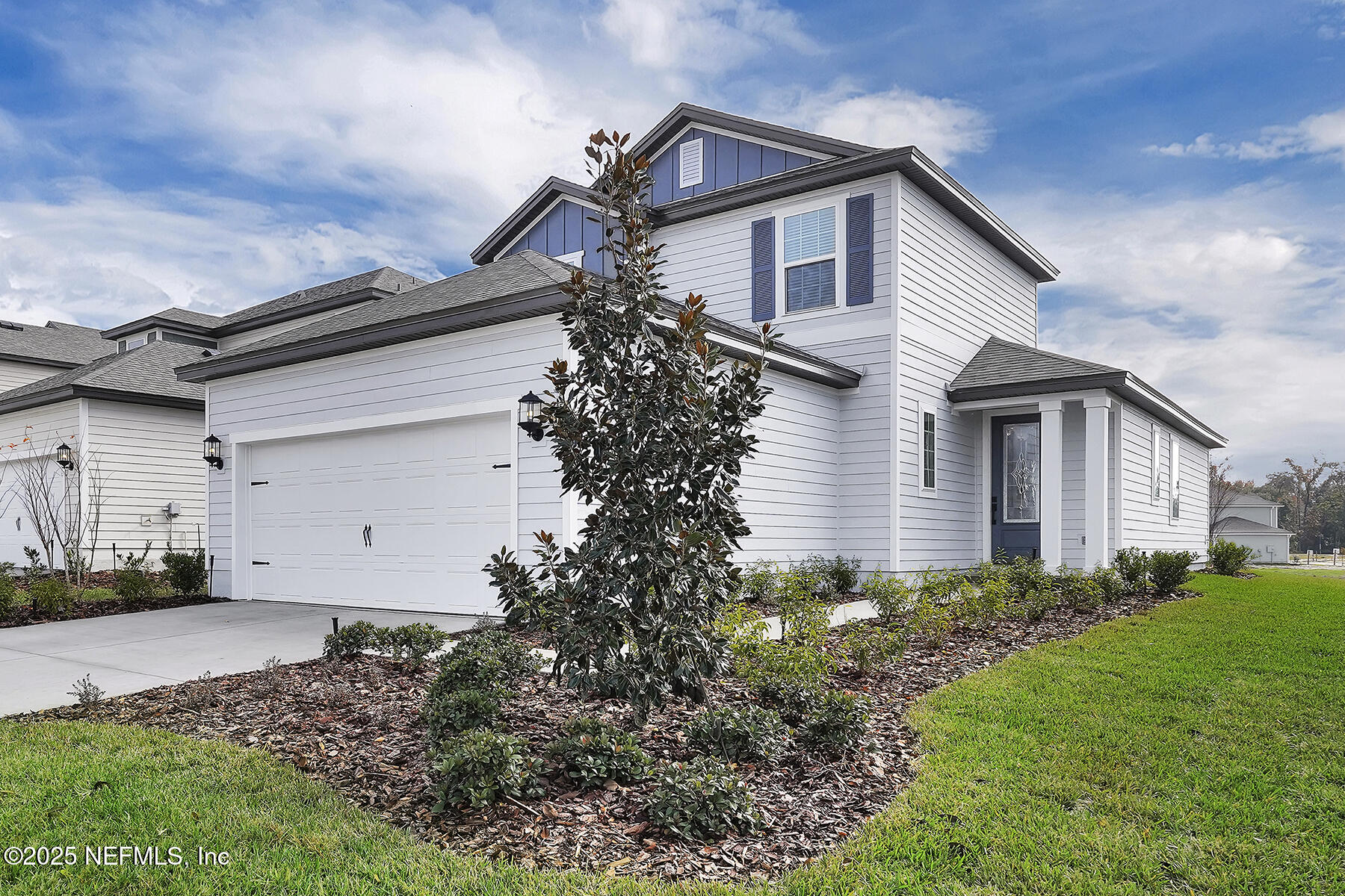 3987 Gareys Ferry Way Middleburg, FL 32068 - Photo 2 of 25 a front view of a house with a yard and garage