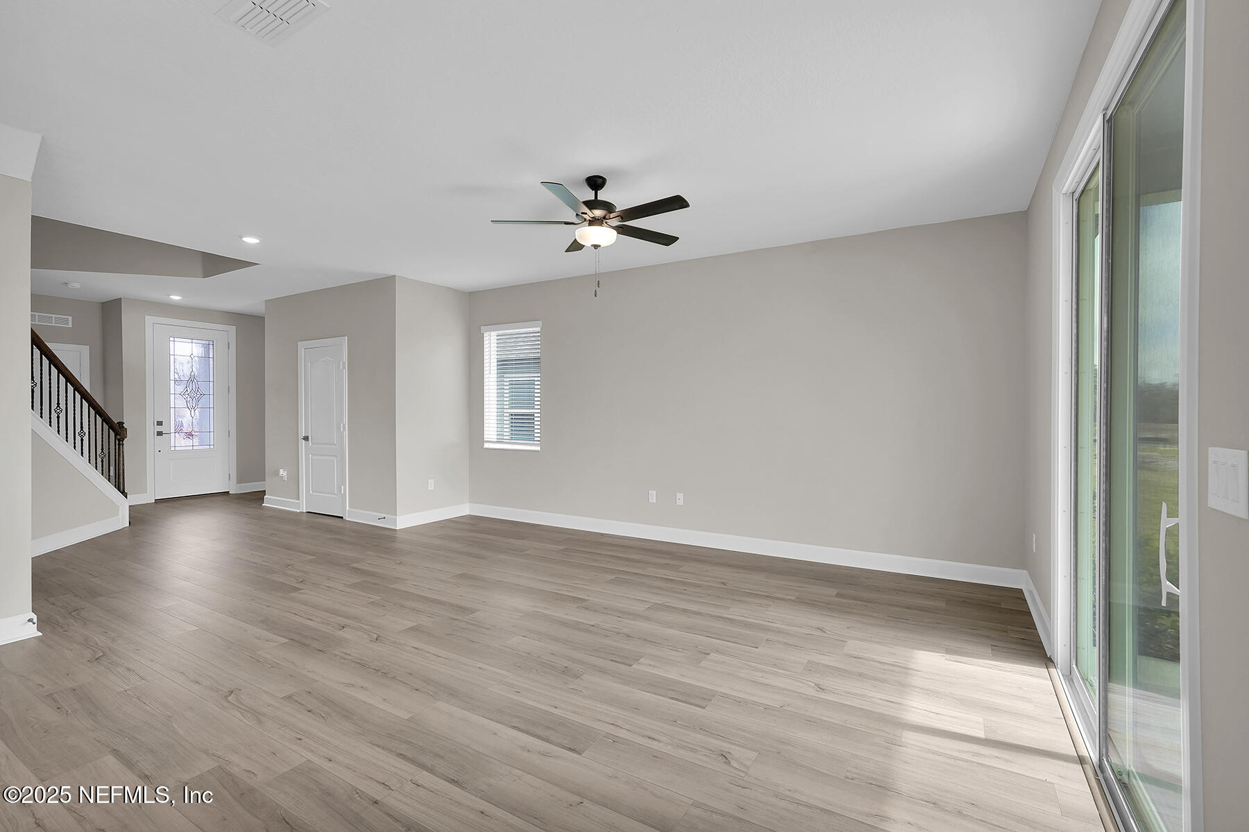3987 Gareys Ferry Way Middleburg, FL 32068 - Photo 4 of 25 wooden floor in an empty room with a window
