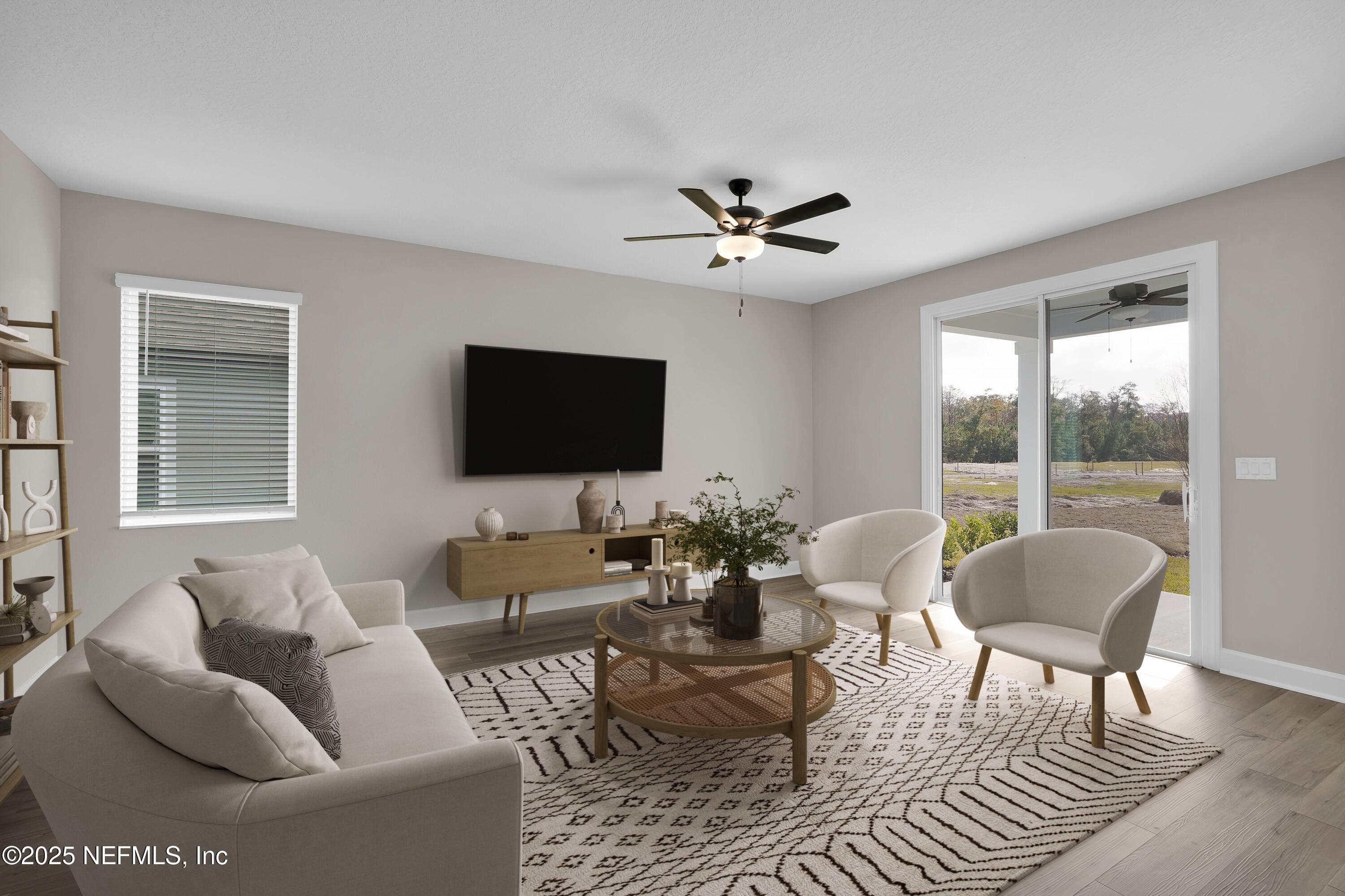 3987 Gareys Ferry Way Middleburg, FL 32068 - Photo 5 of 25 a living room with furniture a flat screen tv and a large window