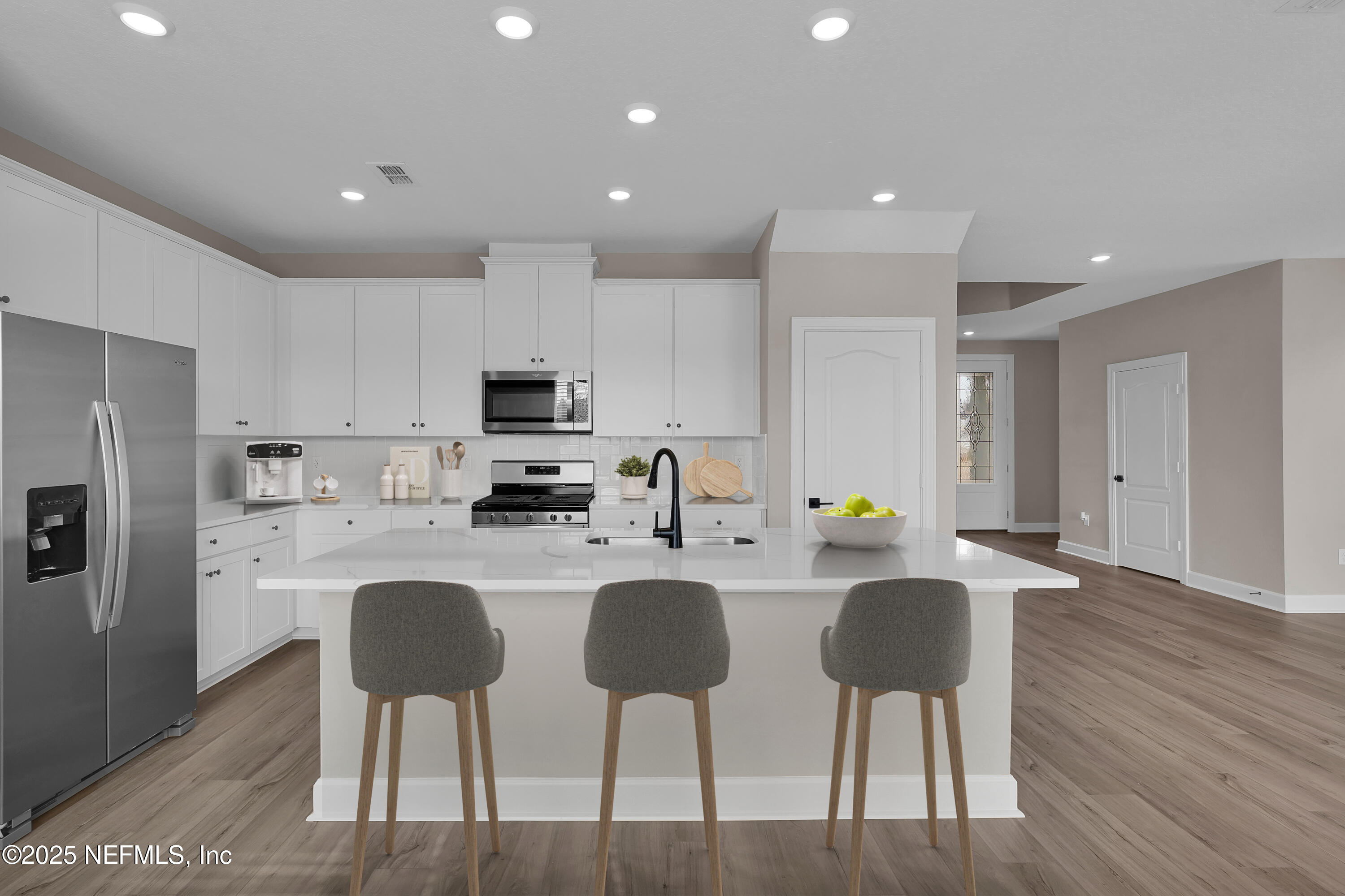 3987 Gareys Ferry Way Middleburg, FL 32068 - Photo 9 of 25 a kitchen with refrigerator and chairs