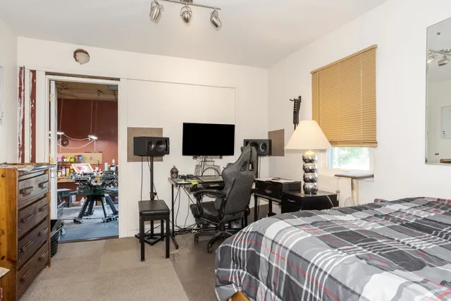 a bedroom with a bed and a flat screen tv