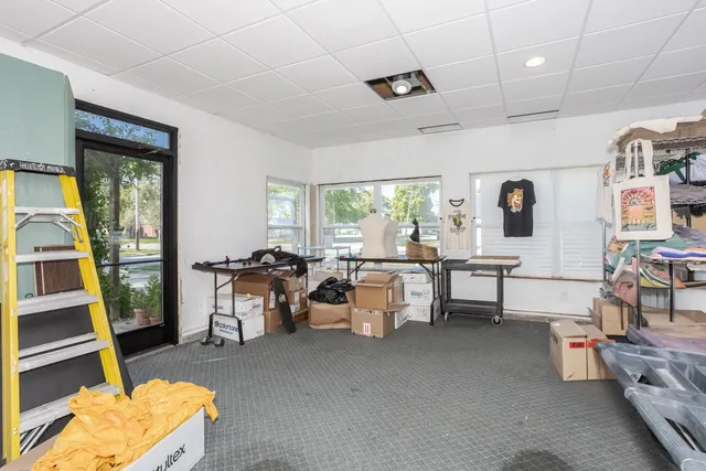 a living room with lots of furniture and a large window