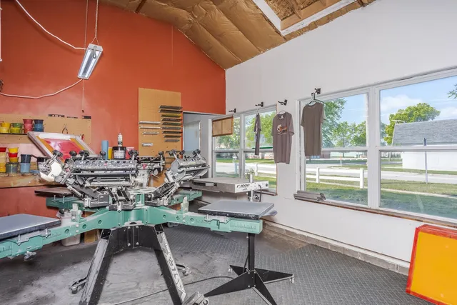 a view of a city from a chairs and table in the balcony