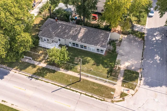 a view of a balcony with a floor to ceiling window and tree