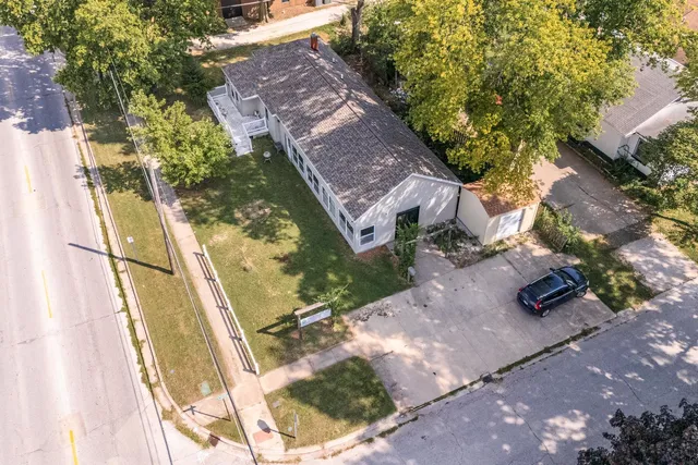 an aerial view of a house with a yard
