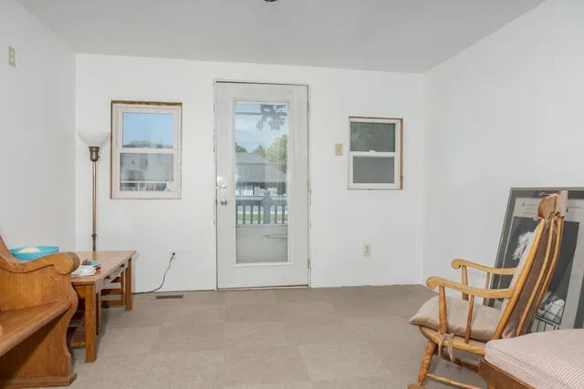 a view of room with furniture and windows
