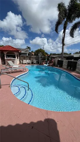 a view of a swimming pool with a yard and mountain view