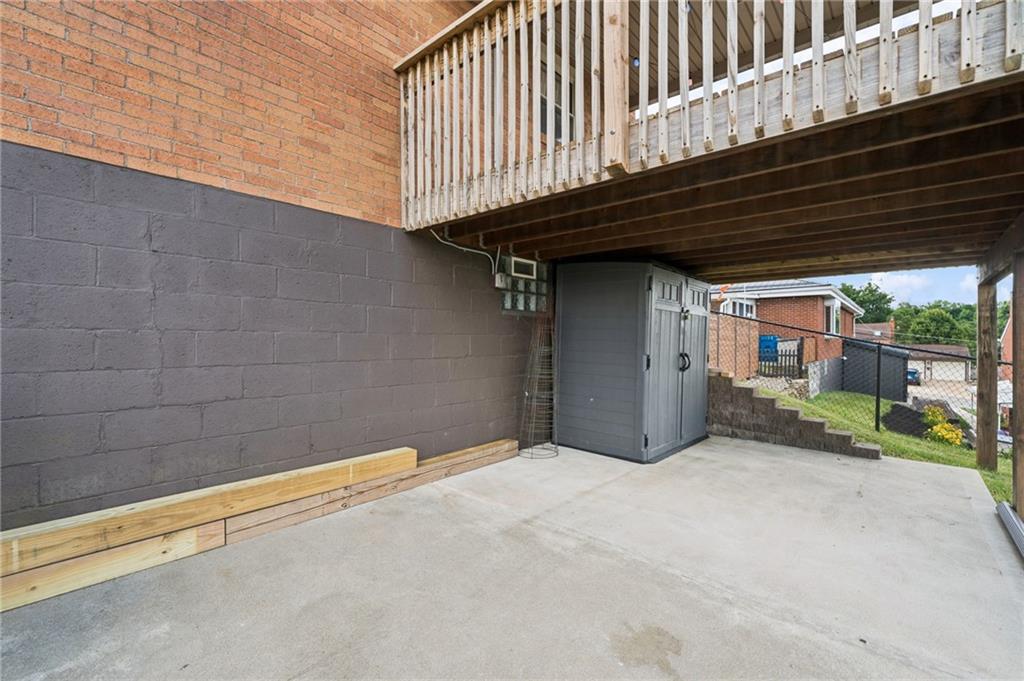 711 Jane Street Pittsburgh, PA 15239 - Photo 26 of 27 Covered concrete patio located under the deck, providing great additional space for outdoor relaxation.
