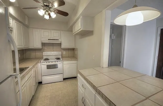 a kitchen with a stove a sink and a refrigerator