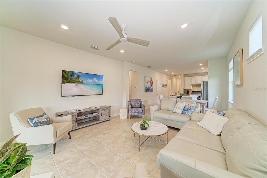 7013 Hanover Court Lakewood Ranch, FL 34202 - Photo 25 of 64 a living room with furniture and a flat screen tv