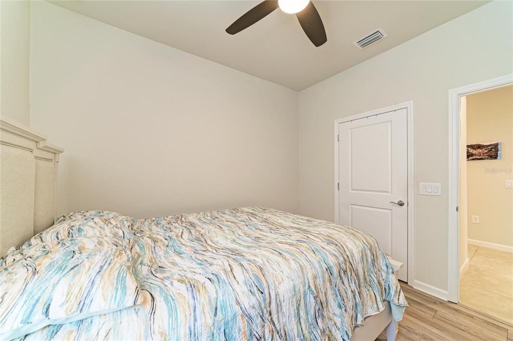 7013 Hanover Court Lakewood Ranch, FL 34202 - Photo 33 of 64 a bedroom with a bed and cabinets