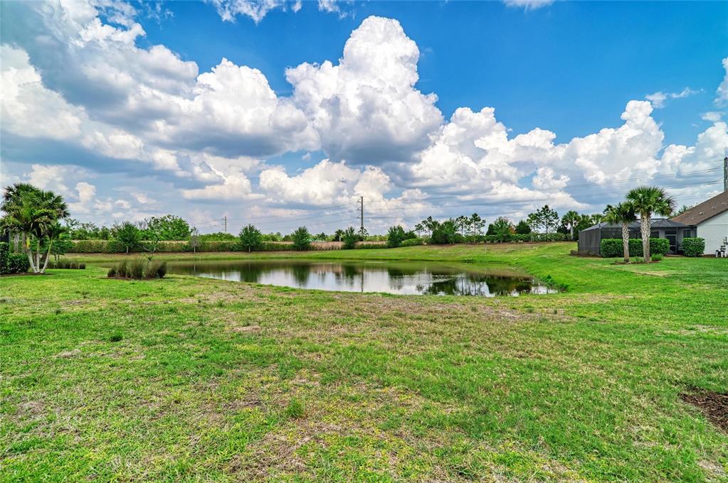 7013 Hanover Court Lakewood Ranch, FL 34202 - Photo 41 of 64 a view of a lake with a big yard